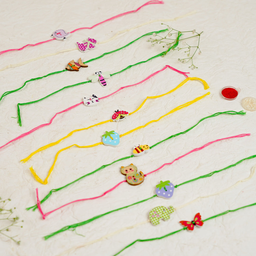 Handmade White Cat Kids Rakhi With Roli Chawal - Multiple Rakhis Laid Out Side by Side