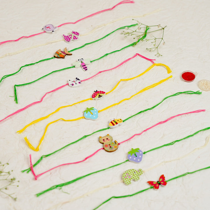 Handmade White Cat Kids Rakhi With Roli Chawal - Multiple Rakhis Laid Out Side by Side