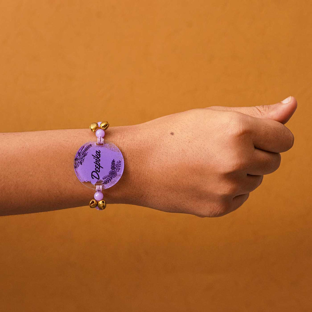 Personalized Hand Painted Name Acrylic Rakhi With Roli Chawal - Worn on Wrist View