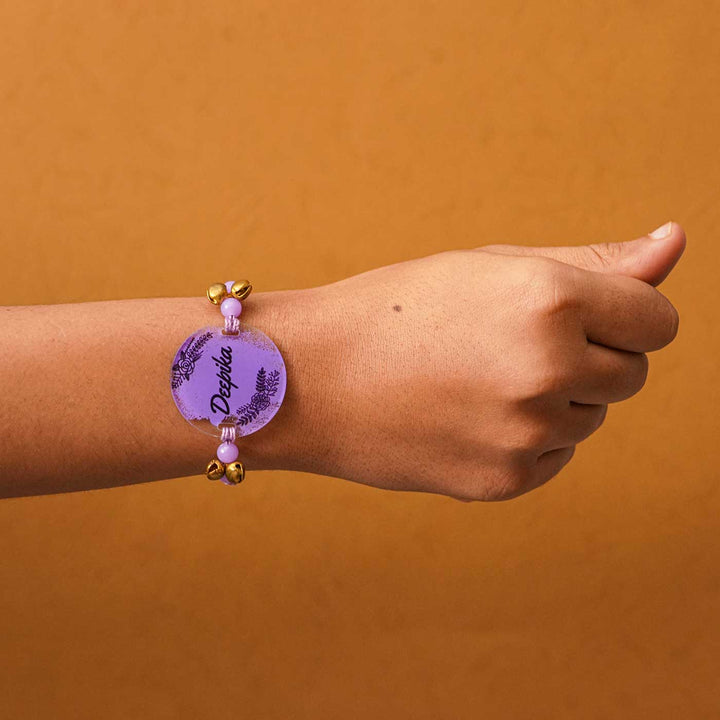Personalized Hand Painted Name Acrylic Rakhi With Roli Chawal - Worn on Wrist View