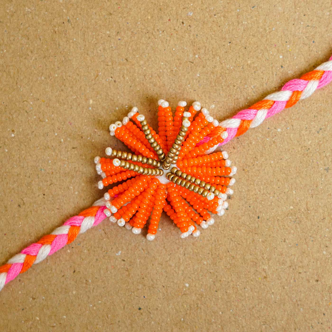 Reusable Beaded Orange Flower Rakhi With Roli Chawal - Close-up of Beaded Centerpiece