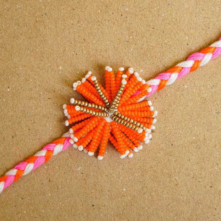 Reusable Beaded Orange Flower Rakhi With Roli Chawal - Close-up of Beaded Centerpiece