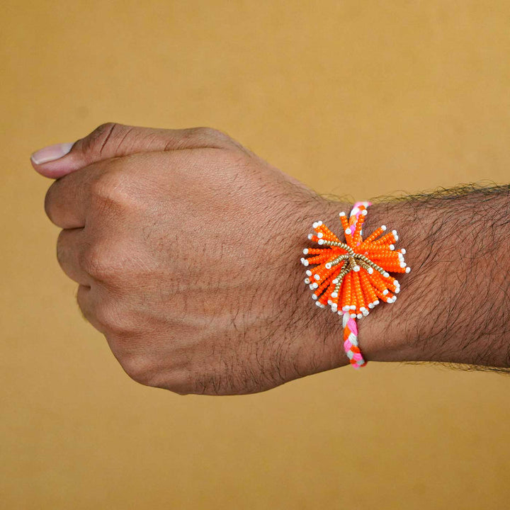 Reusable Beaded Orange Flower Rakhi With Roli Chawal - Bracelet Worn on Wrist