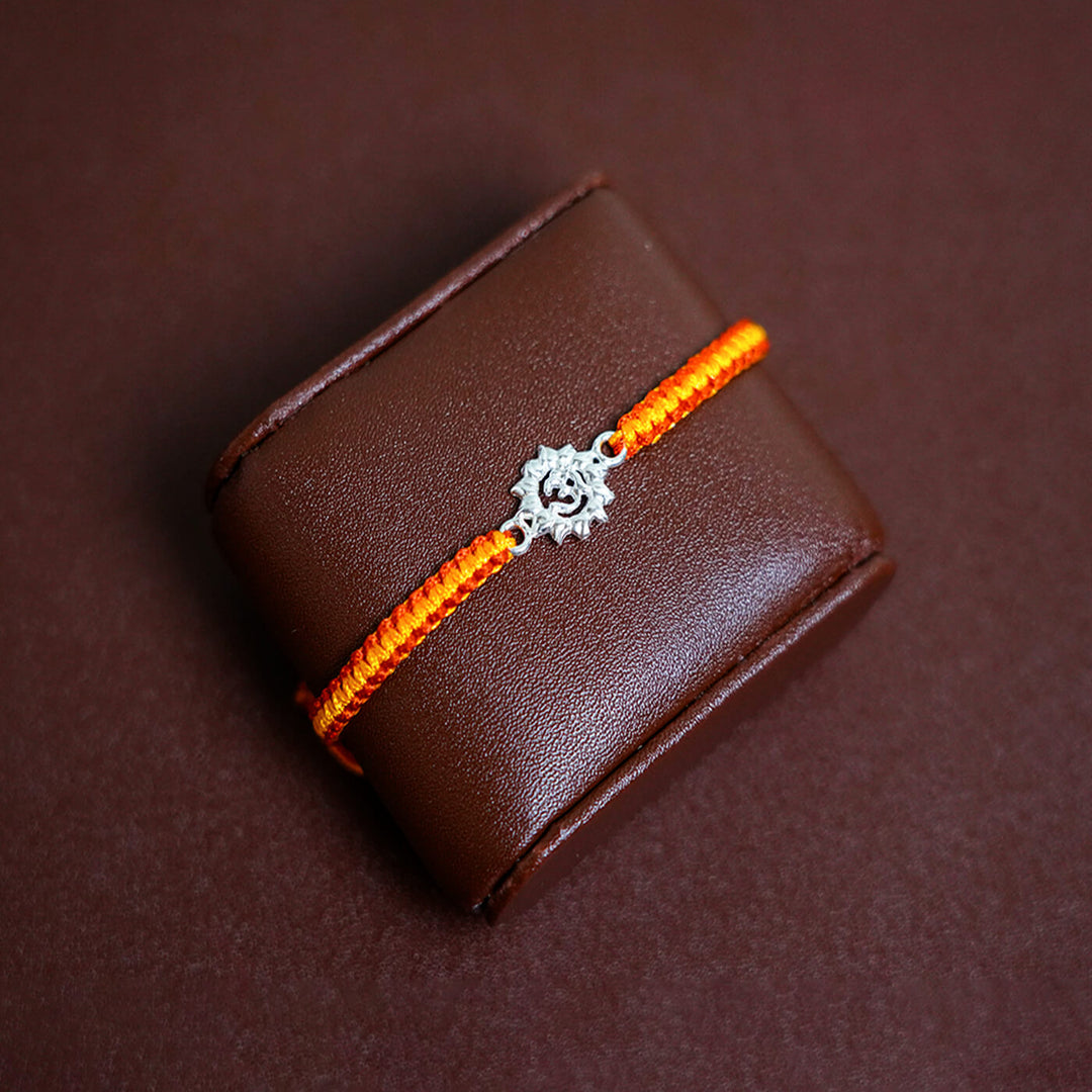 Handcrafted Silver Motif Adjustable Rakhi With Rice Roli 2 - Bracelet Displayed on Cushion
