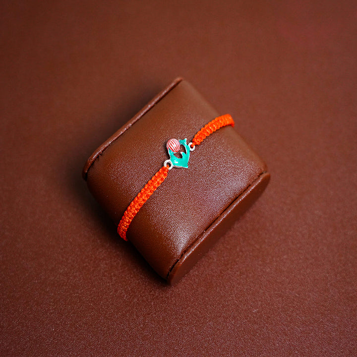 Handcrafted Silver Motif Adjustable Rakhi For Kids With Rice & Roli