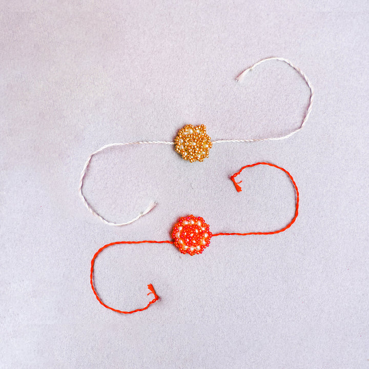 Handcrafted Rose Glass Beads Rakhi Set Of 2 - Flat Lay of Two Rakhis