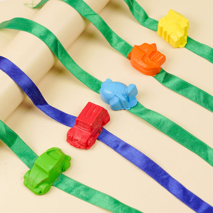 Reusable Non Toxic Vehicle Theme Wax Kids Rakhi Set Of 5 - Toys arranged on ribbon lines