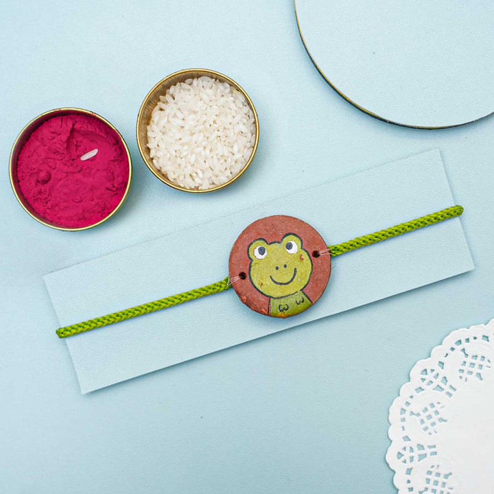 Hand Painted Frog Terracotta Rakhi With Roli Chawal For Kids Copy - Styled with Decorative Items