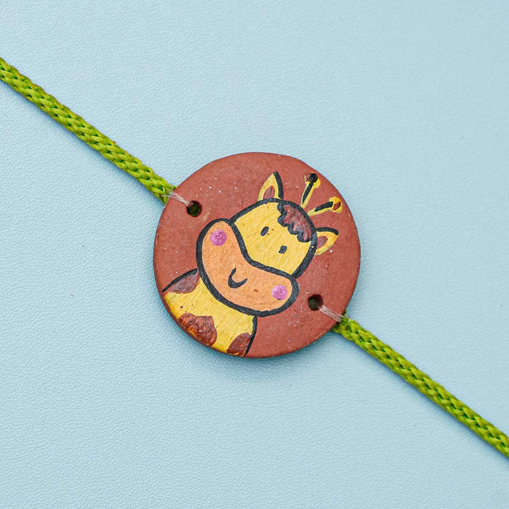 Hand Painted Giraffe2 Terracotta Rakhi With Roli Chawal For Kids - Close-up of Animal Charm