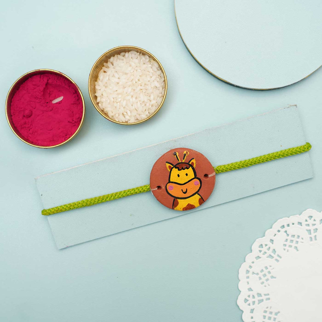 Hand Painted Giraffe2 Terracotta Rakhi With Roli Chawal For Kids - Styled with Ritual Accessories