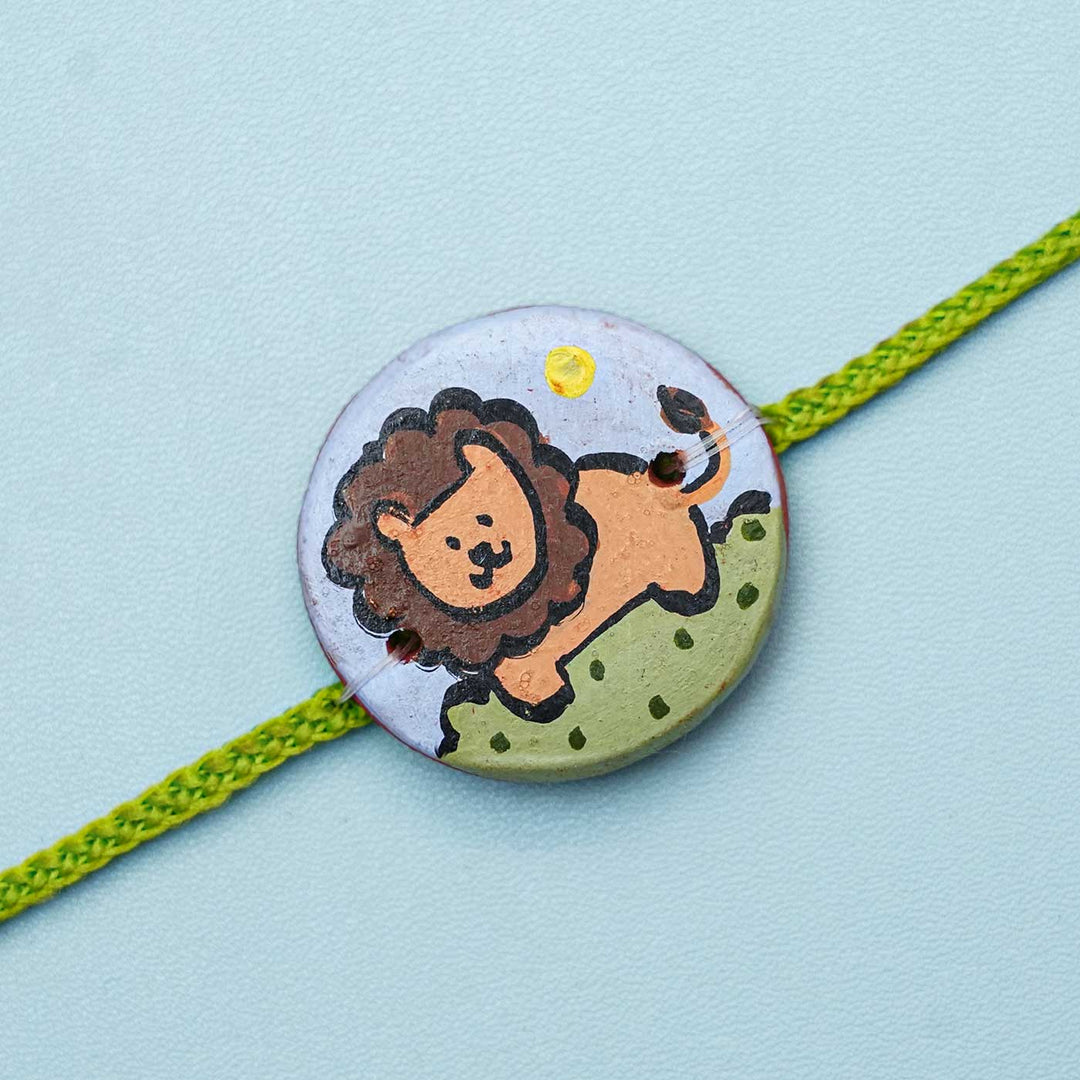 Personalized Animal Theme Terracotta Rakhi With Roli Chawal For Kids 3 - Close-up of Lion Design