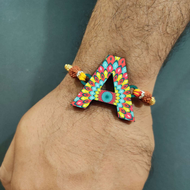 Personalized Handmade Printed Alphabet Wooden Rudraksha Rakhi With Roli Chawal - Wrist Wearing Display