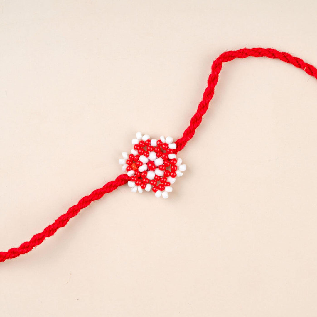 Handcrafted Glass Beads Sitara Rakhi 7 - Close-up of red and white rakhi