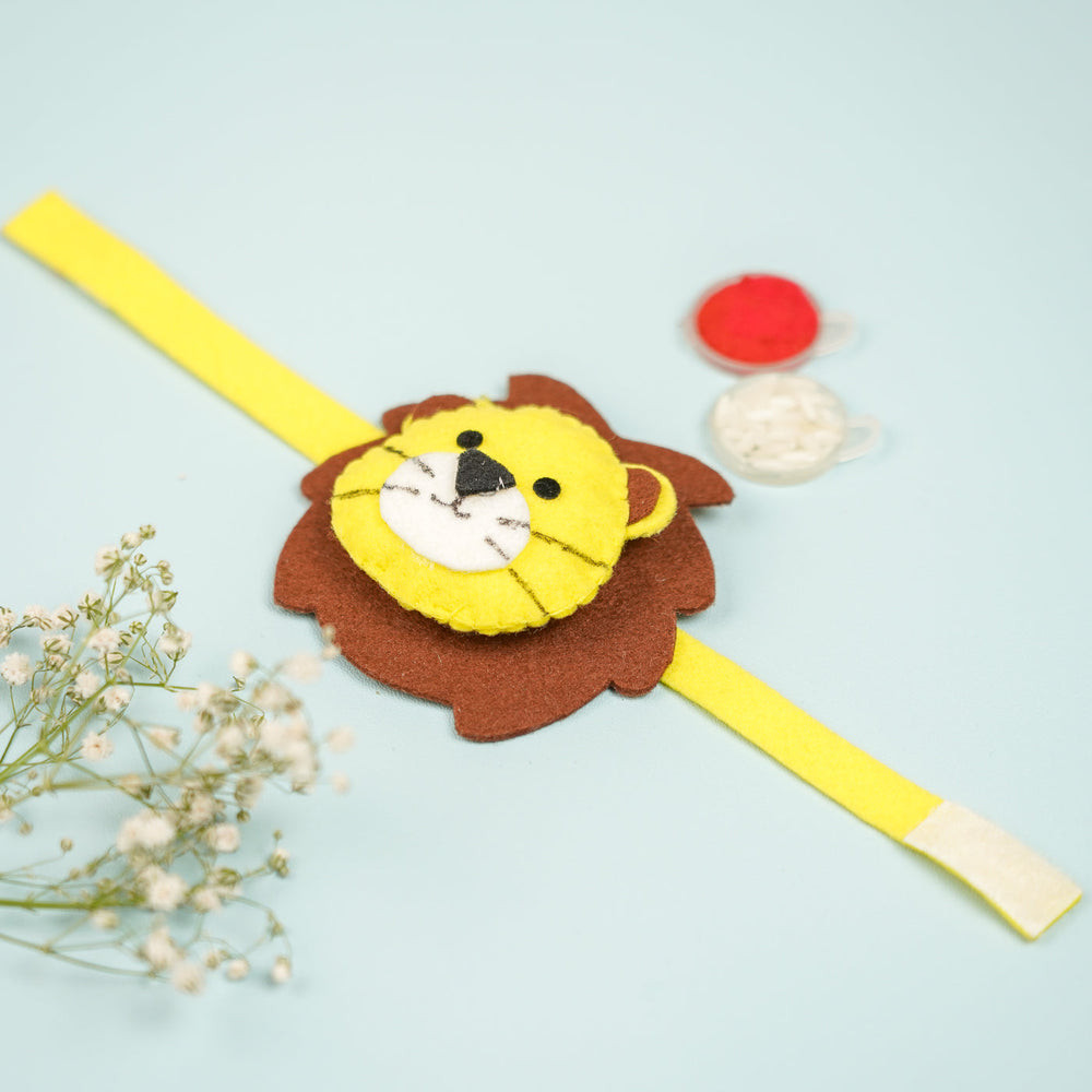 Handmade Lion Theme Felt Kids Rakhi With Roli Chawal 2 - Close-up Front View with Paint Pots
