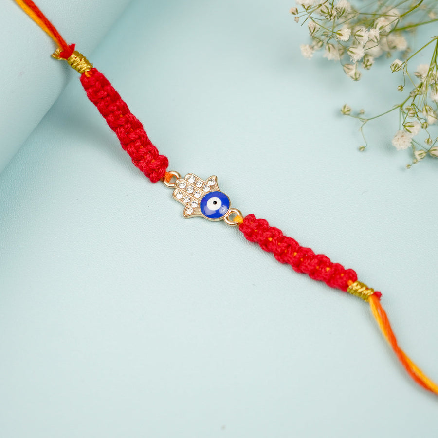 Handmade Macrame Hamsa Evil Eye Metal Rakhi With Roli Chawal - Close-up of Bracelet Centerpiece