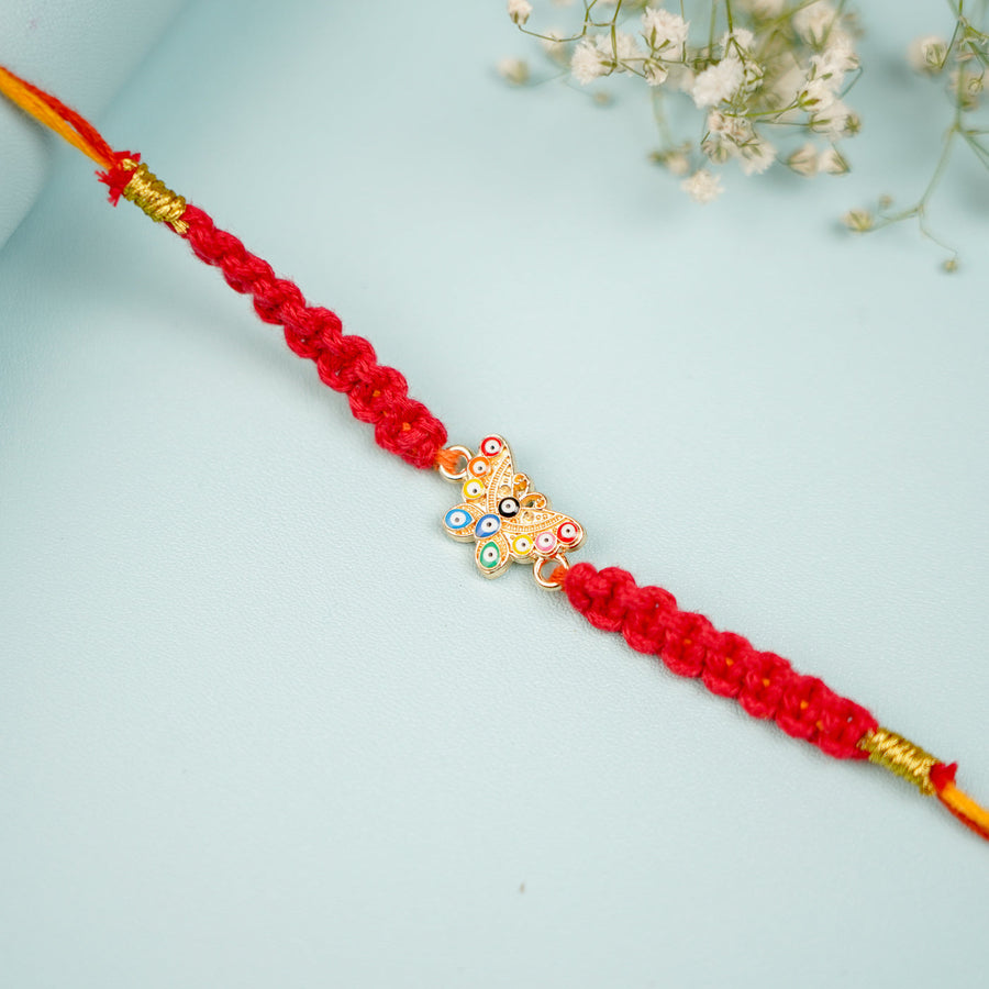 Handmade Macrame Butterfly Evil Eye Metal Rakhi With Roli Chawal - Close-up of central charm