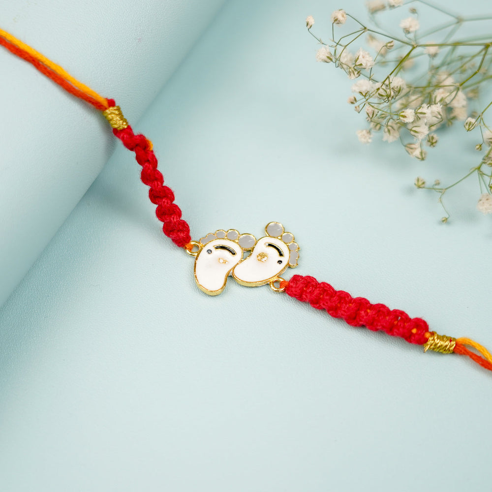 Handmade Macrame Baby Feet Theme Metal Rakhi With Roli Chawal - Close-up of Centerpiece Detail
