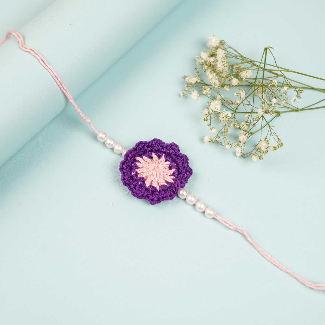 Handmade Crochet Purple Floral And Beads Rakhi With Roli Chawal For Bhaiya Bhabhi And Kids - Flat Lay of Full Bracelet