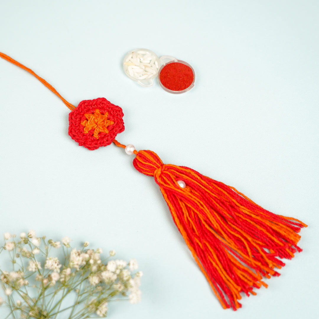 Handmade Crochet Red Floral And Beads Rakhi With Roli Chawal For Bhaiya Bhabhi And Kids - Close-up of Tassel and Accessories