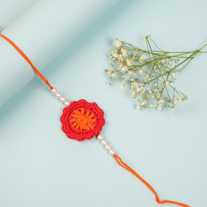 Handmade Crochet Red Floral And Beads Rakhi With Roli Chawal For Bhaiya Bhabhi And Kids - Close-up of Crochet Flower with Beads