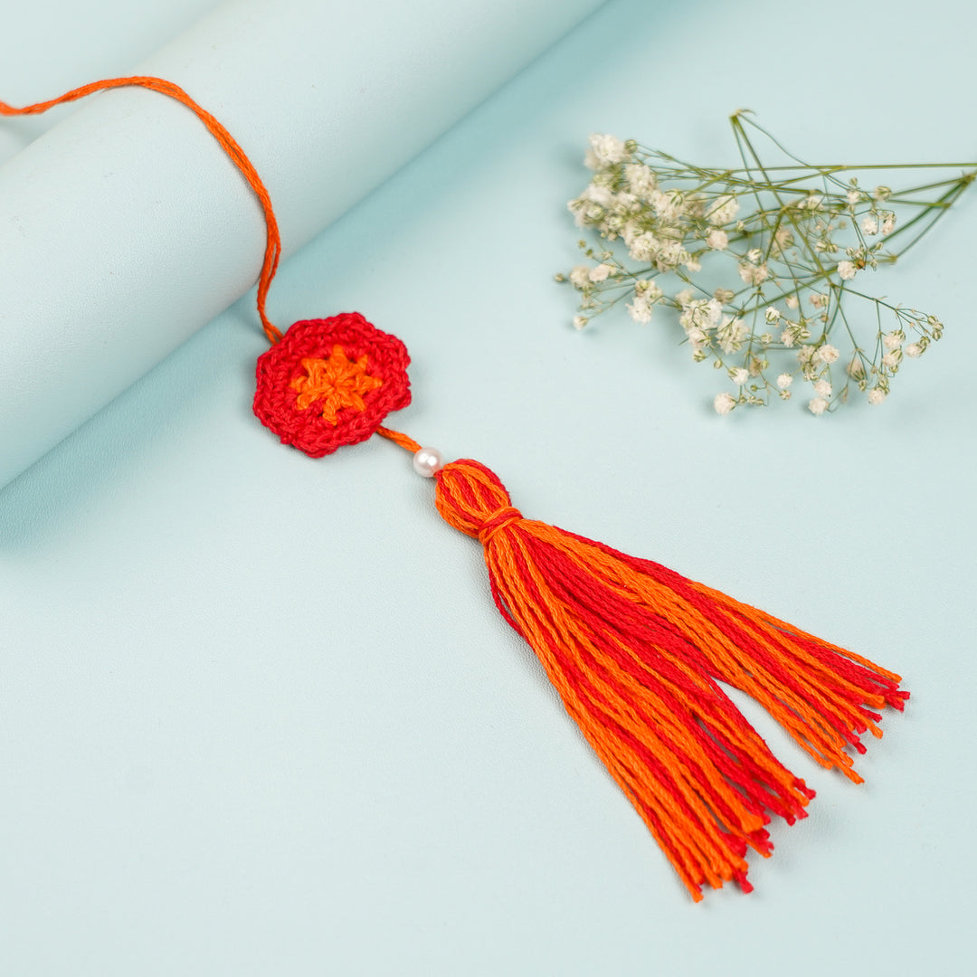 Handmade Crochet Red Floral And Beads Rakhi With Roli Chawal For Bhaiya Bhabhi And Kids - Close-up of Tassel Hanging View