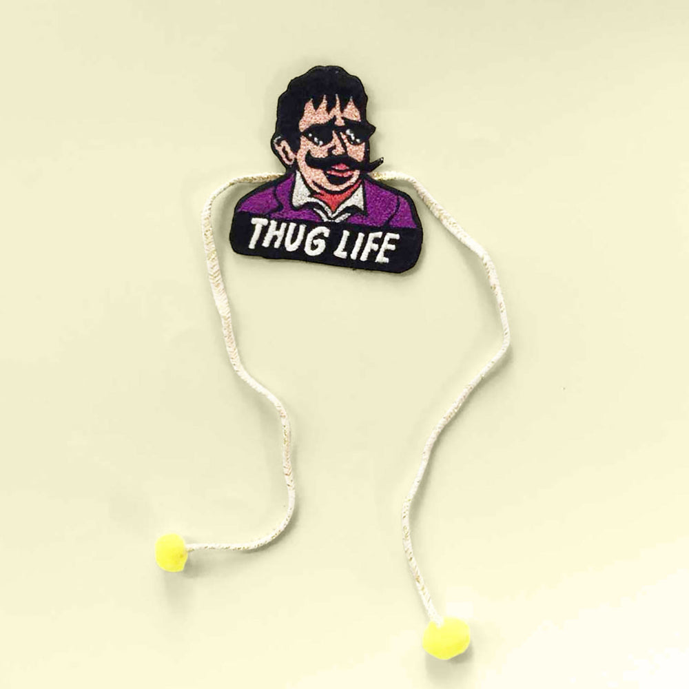 Handmade Reusable Thug Life Pom Pom Felt Rakhi For Brother - Flat Lay of Embroidered Rakhi