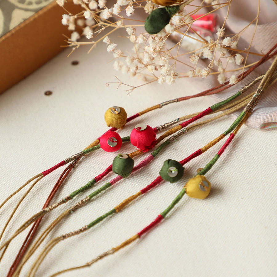 Handmade Reusable Colorful Pods Upcycled Fabric Rakhi With Roli Chawal For Brother Set Of 3 - Close-up of fabric beads