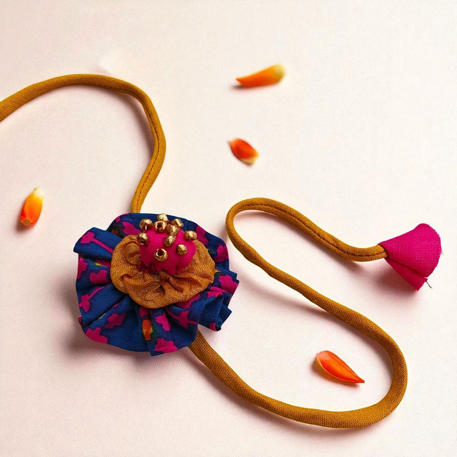 Handmade Beaded Flower Design Upcycled Fabric Rakhi With Roli Chawal For Brother - Close-up Front View
