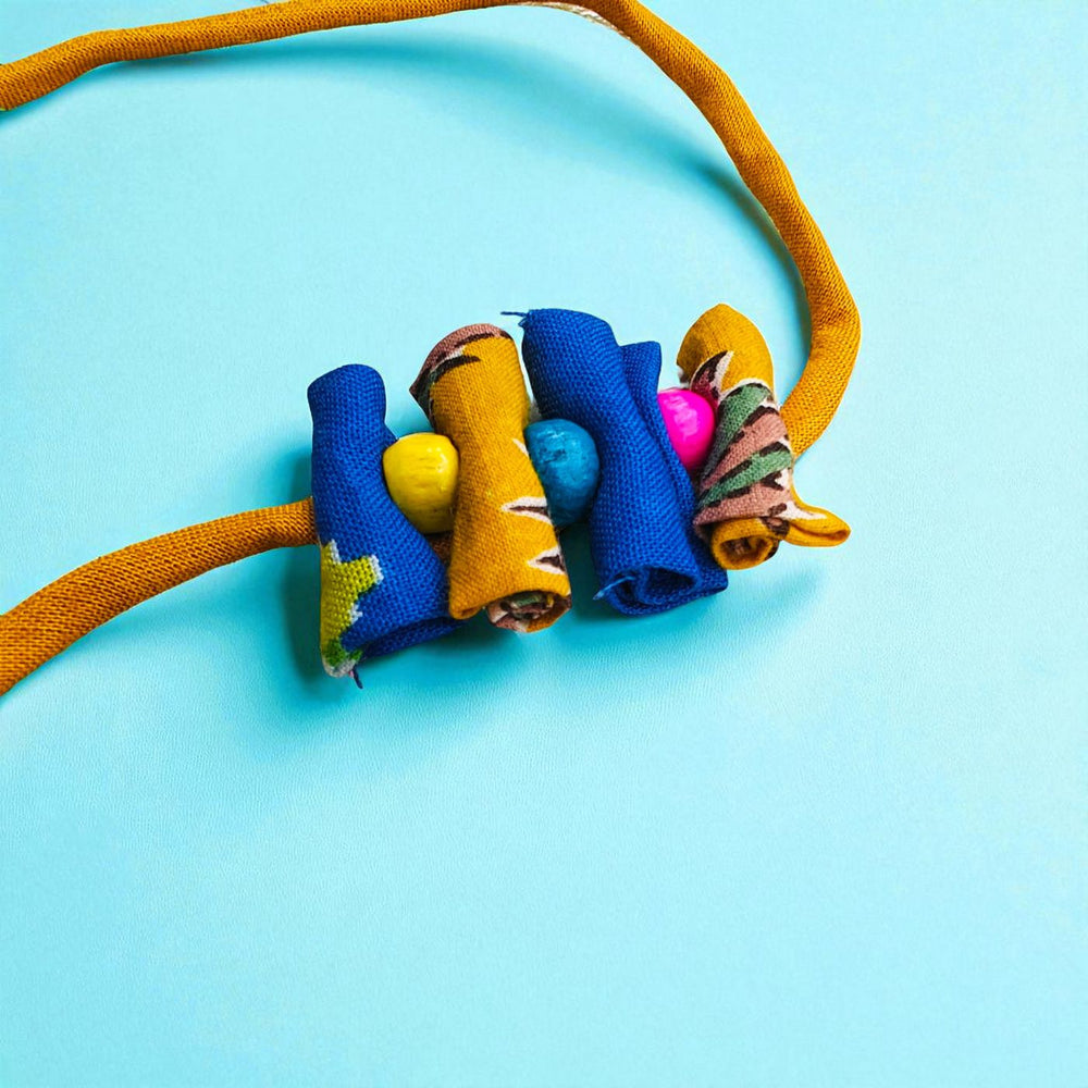 Handmade Roll Stacked Design Upcycled Fabric Rakhi With Roli Chawal For Brother - Side angle of colorful fabric beads