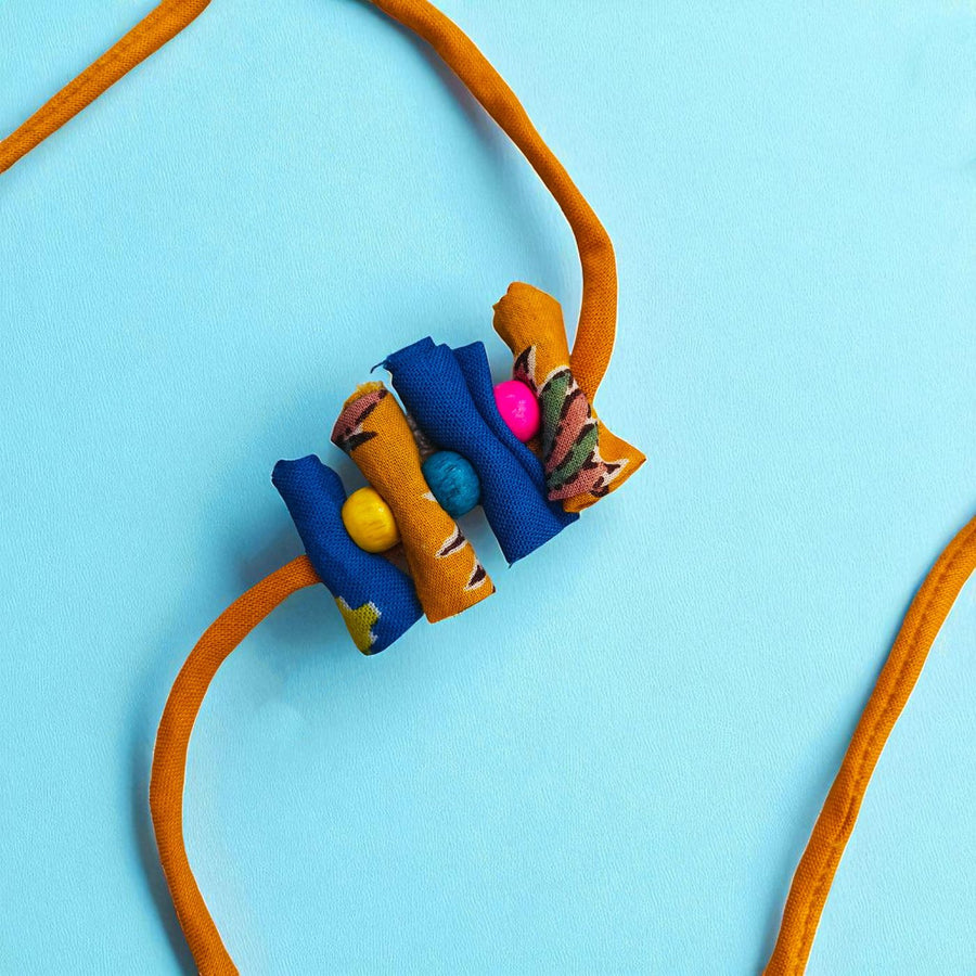 Handmade Roll Stacked Design Upcycled Fabric Rakhi With Roli Chawal For Brother - Close-up of fabric bead cluster
