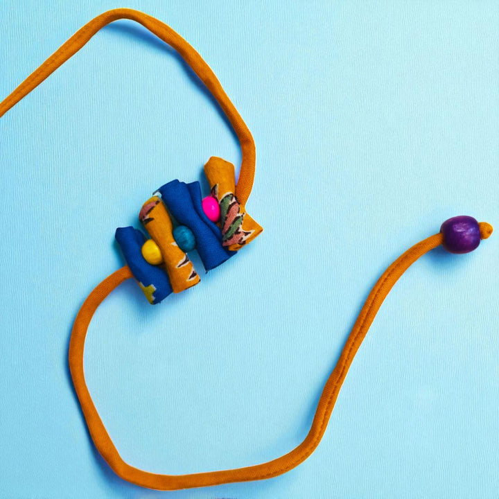 Handmade Roll Stacked Design Upcycled Fabric Rakhi With Roli Chawal For Brother - Full view of necklace with bead closure