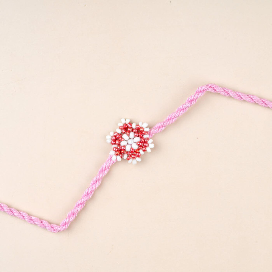 Handcrafted Glass Beads Sitara Rakhi 7 - Close-up of pink rakhi design
