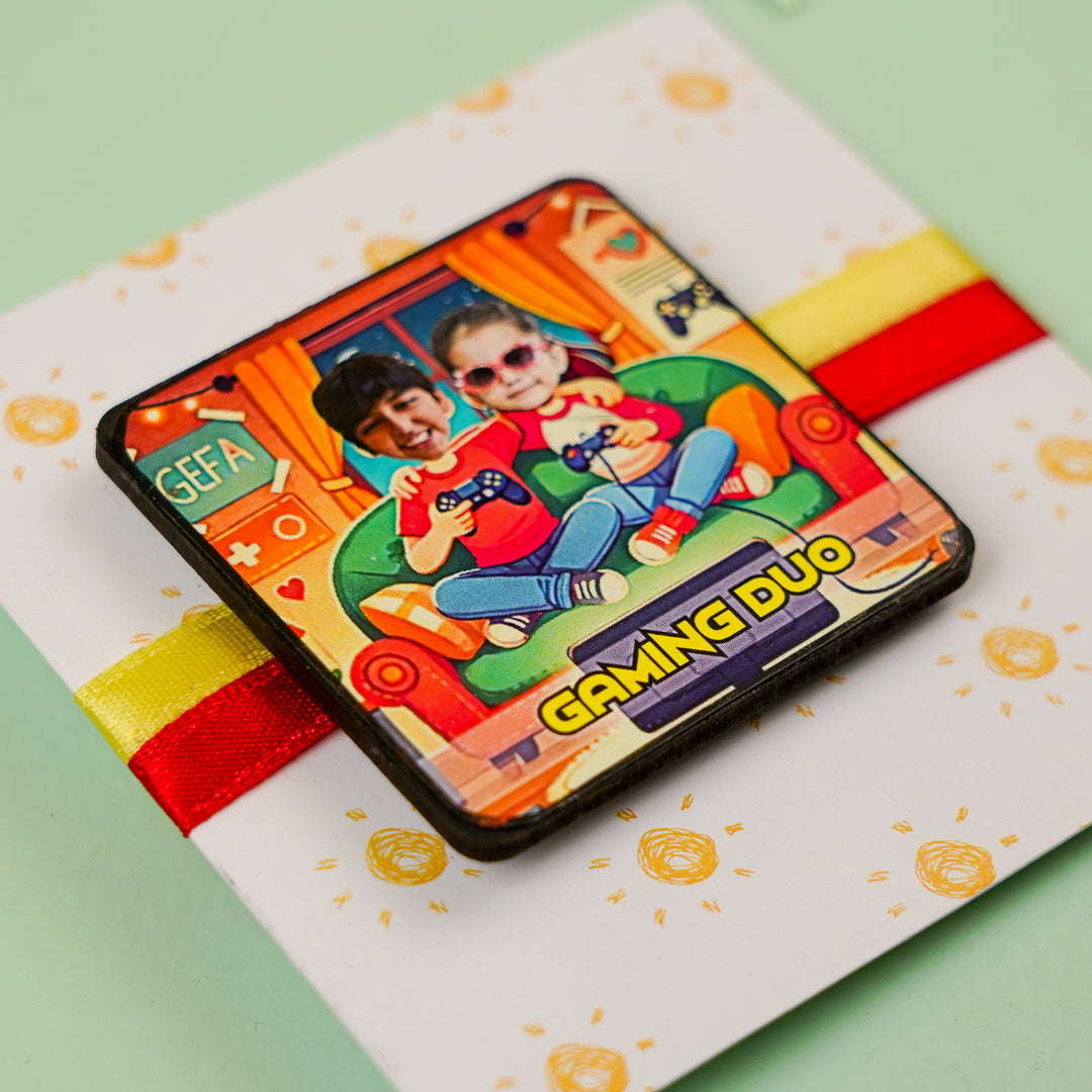 Photo Personalized Handmade Reusable Caricature Gaming Duo Mdf Wood Rakhi With Roli Chawal For Siblings - Angled close-up of badge on card