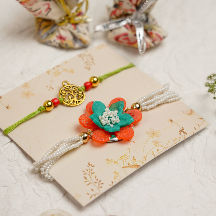 Orange Green Pearl And Tree Charm Resin Bracelet Rakhi With Roli Chawal For Bhaiya And Bhabhi - Angled View on Card