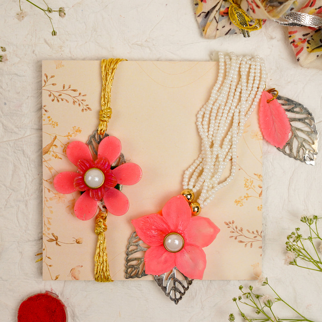 Pink White Pearls And Charm Resin Bracelet Rakhi With Roli Chawal For Bhaiya And Bhabhi - Top-Down Display on Decorative Card