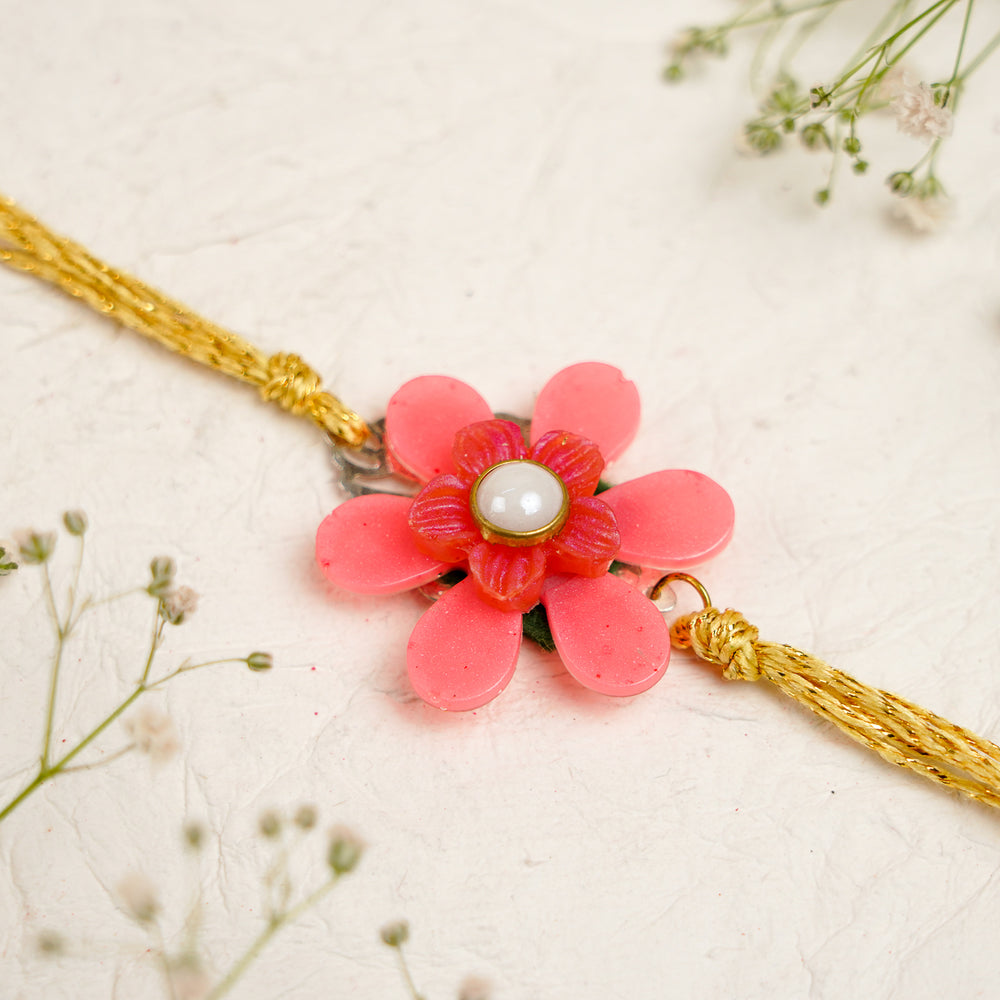 Pink White Pearls And Charm Resin Bracelet Rakhi With Roli Chawal For Bhaiya And Bhabhi - Close-up of Flower Pendant Bracelet