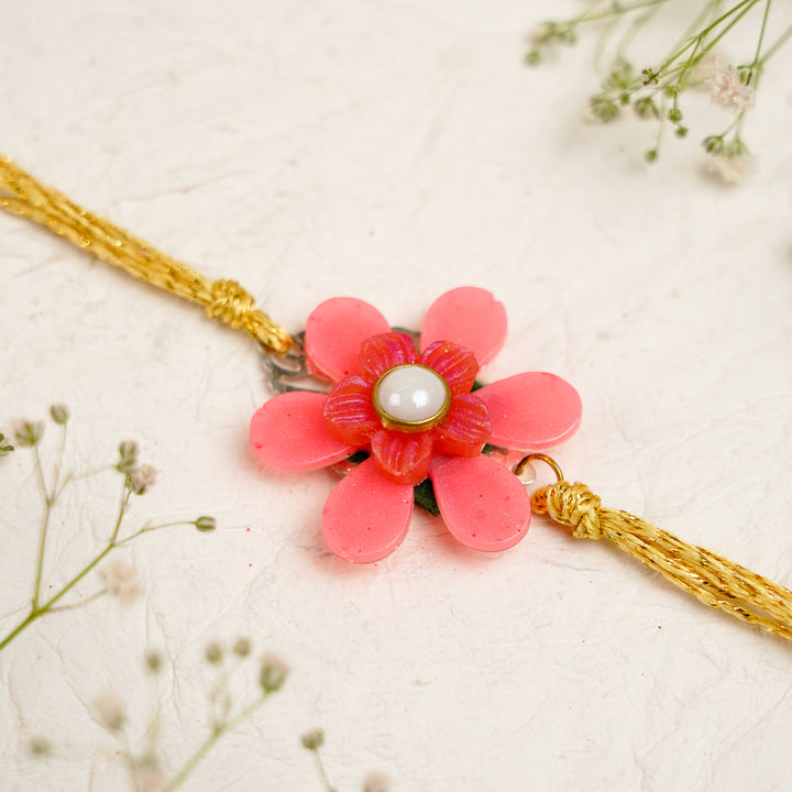 Pink White Pearls And Charm Resin Bracelet Rakhi With Roli Chawal For Bhaiya And Bhabhi - Close-up of Flower Pendant Bracelet
