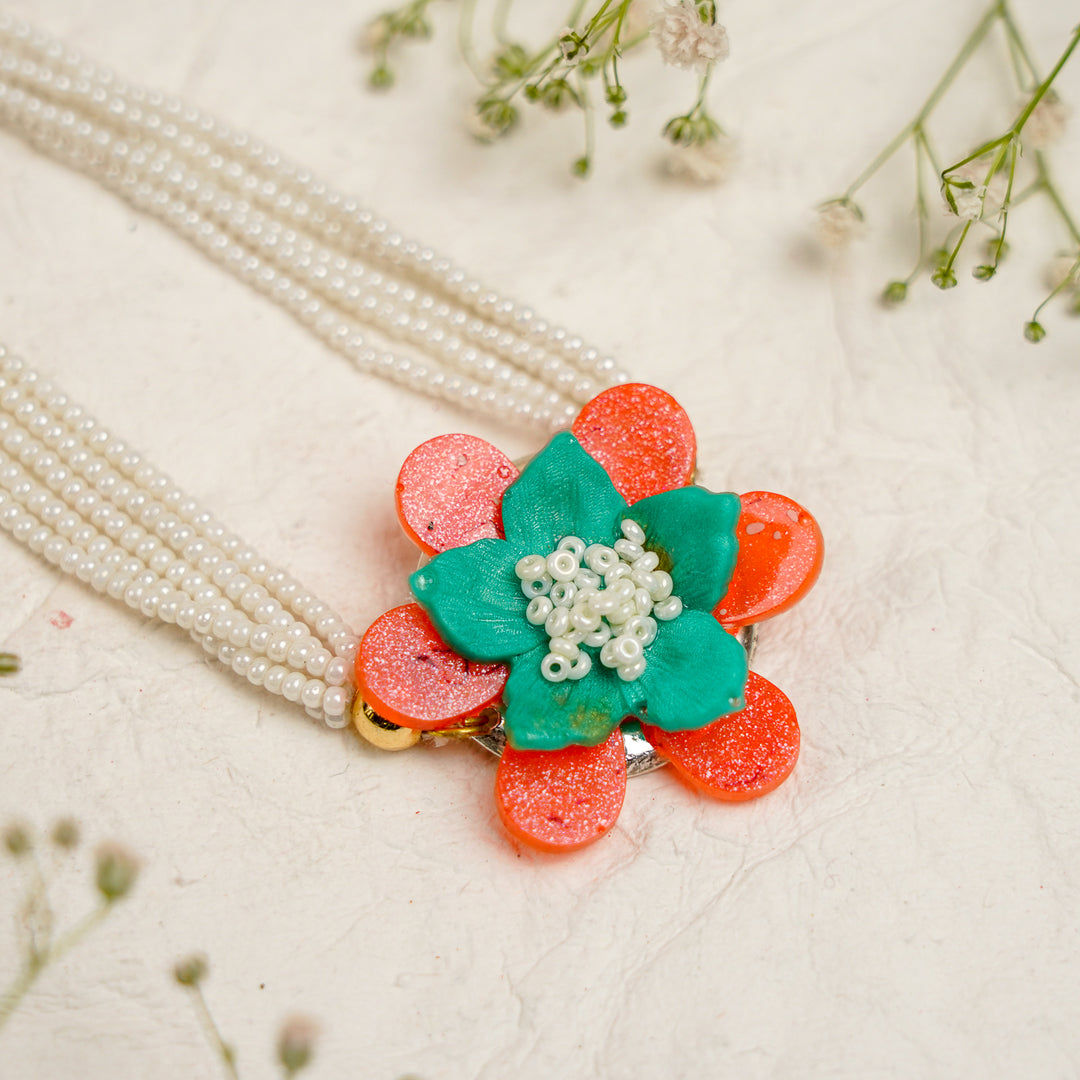 Orange Green Pearl And Tree Charm Resin Bracelet Rakhi With Roli Chawal For Bhaiya And Bhabhi - Close-up of Flower Detail