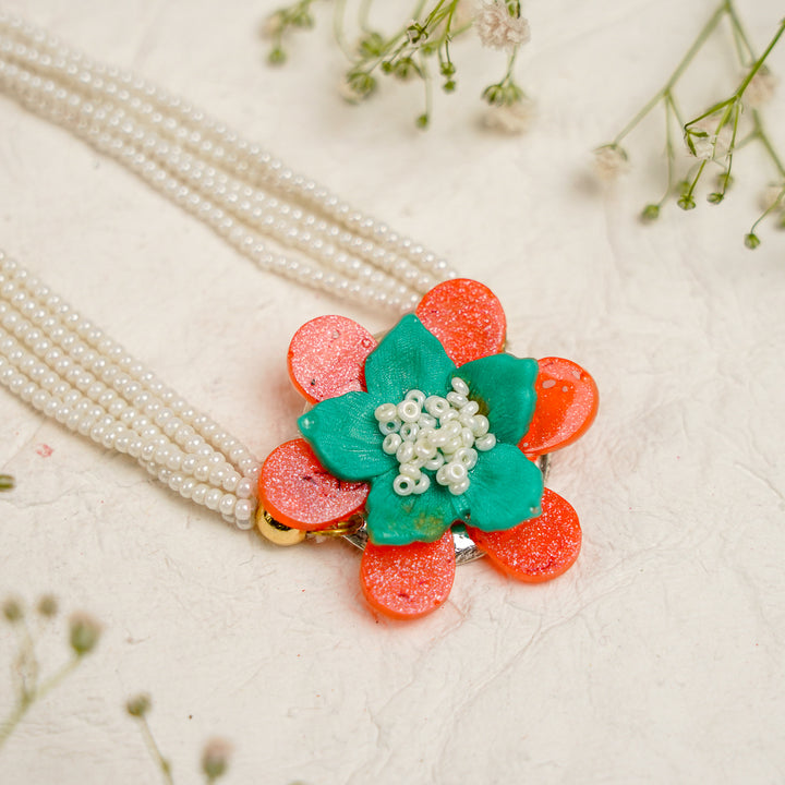 Orange Green Pearl And Tree Charm Resin Bracelet Rakhi With Roli Chawal For Bhaiya And Bhabhi - Close-up of Flower Detail