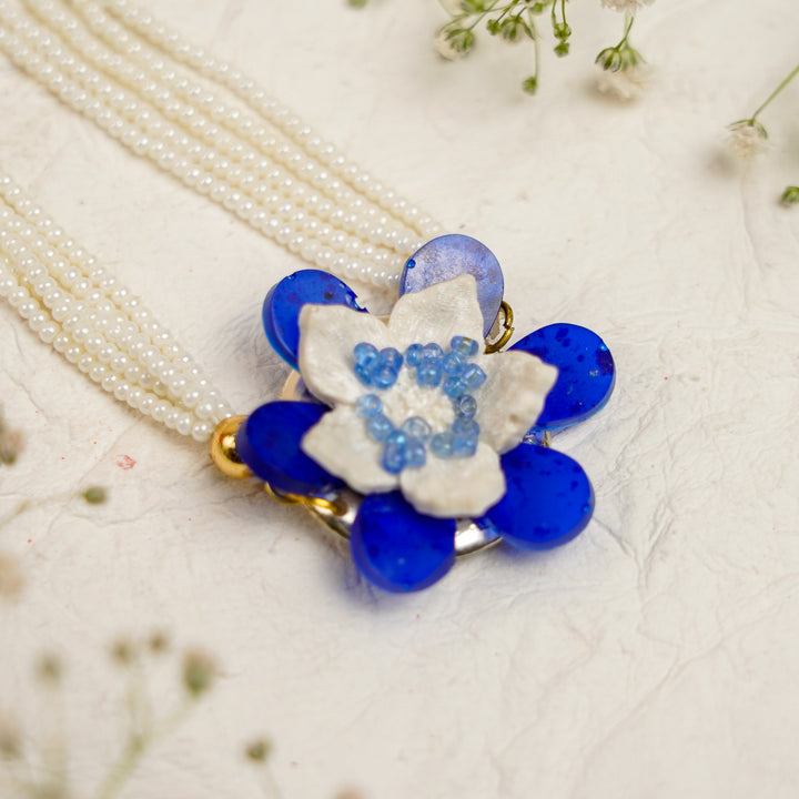 Blue White Pearls And Zari Resin Bracelet Rakhi With Roli Chawal For Bhaiya And Bhabhi - Close-up of White Flower Rakhi