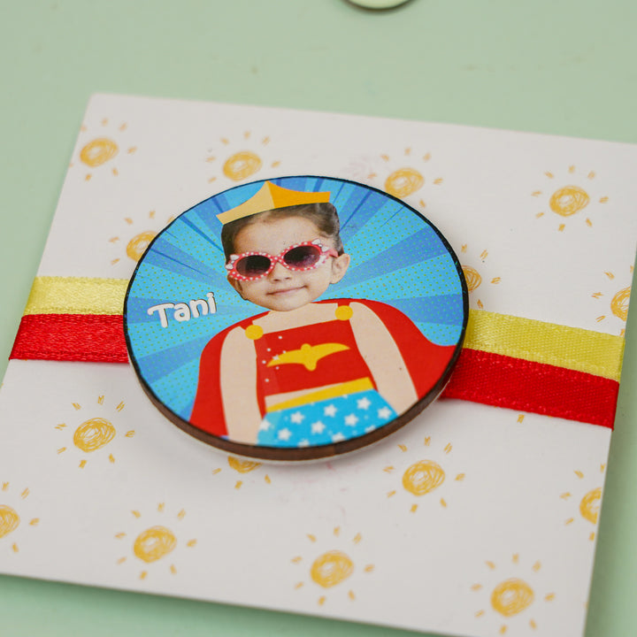 Photo Personalized Handmade Reusable Caricature Wonder Women Mdf Wood Kids Rakhi With Roli Chawal - Angled Close-up on Badge