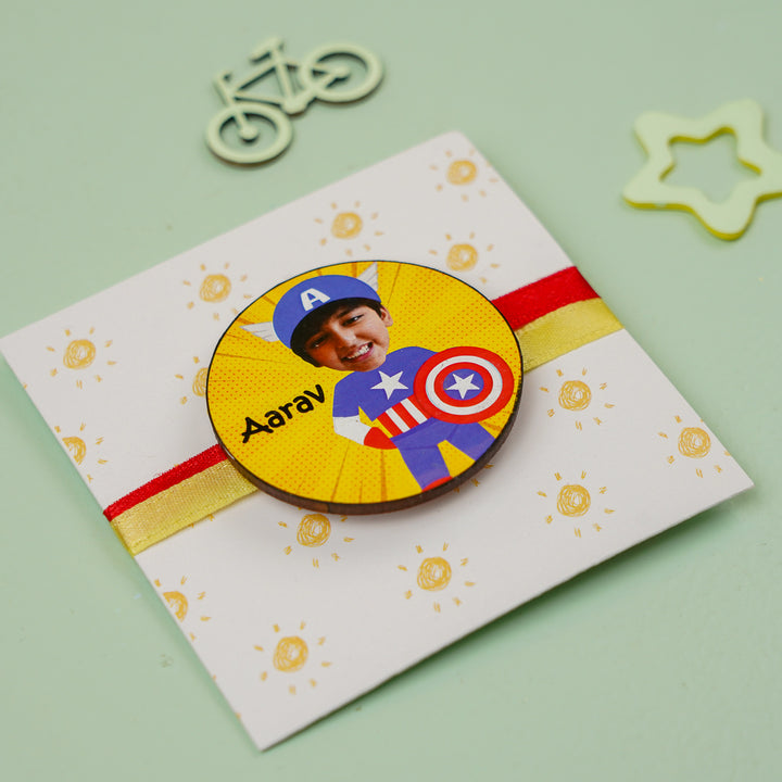 Photo Personalized Handmade Reusable Caricature Captain America Mdf Wood Kids Rakhi With Roli Chawal - Angled View on Decorative Card