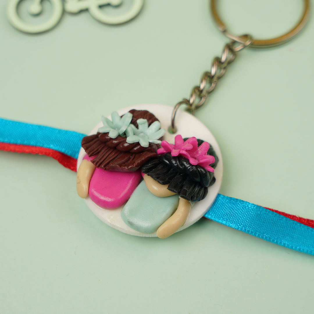 Handmade Reusable Twin Sisters Keychain Clay Rakhi With Roli Chawal - Close-up View