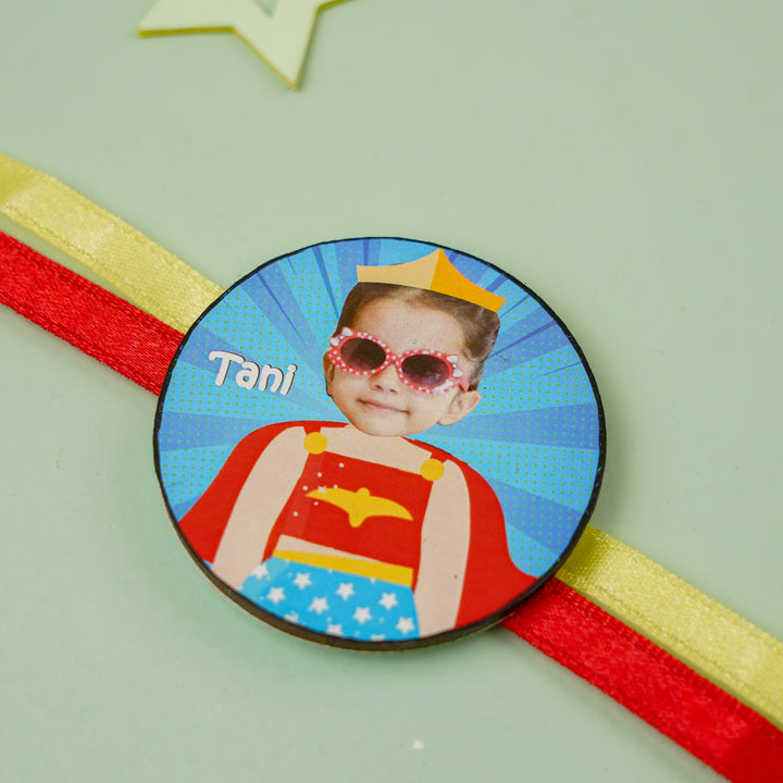 Photo Personalized Handmade Reusable Caricature Wonder Women Mdf Wood Kids Rakhi With Roli Chawal - Close-up on Circular Badge