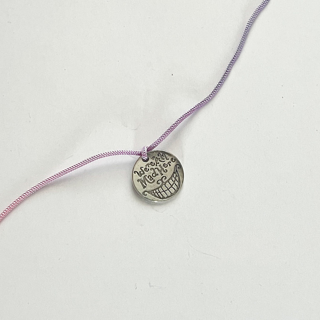 Engraved "We Are All Mad Here" Quote Metal Charm Rakhi With Roli Chawal for Brother