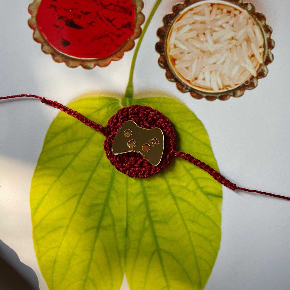 Handmade Crochet Joystick Theme Cotton Rakhi With Roli Chawal - Flat Lay with Controller Charm