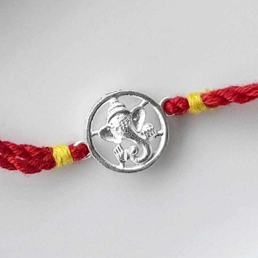 Handmade Ganesha Design Silver Rakhi Hamper With Roli Chawal For Brother - Close-up of charm detail