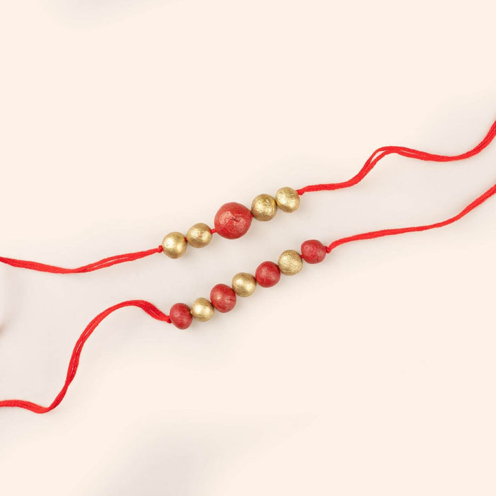 Handcrafted Terracotta Rakhi Hamper With Rice Roli - Close-up of Rakhi Beads