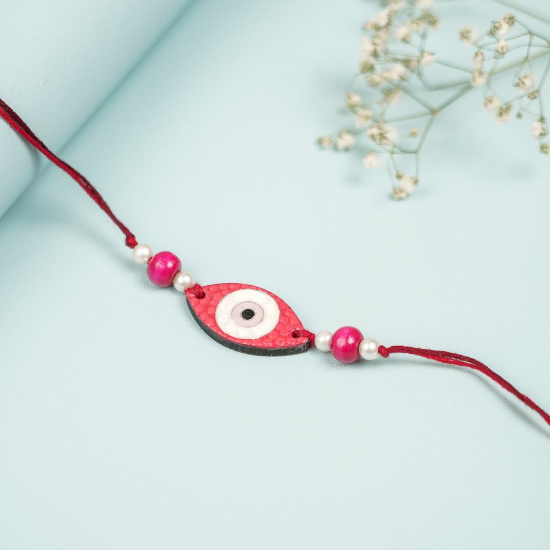 Customized Hand Painted Evil Eye Design Mdf Wood Rakhi - Close-up on Red Beaded Bracelet