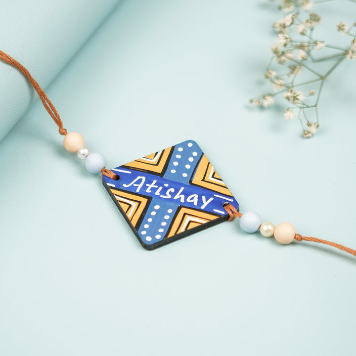 Personalized Hand Painted Round Design Mdf Wood Rakhi - Flat Lay Displaying Square Pendant Details